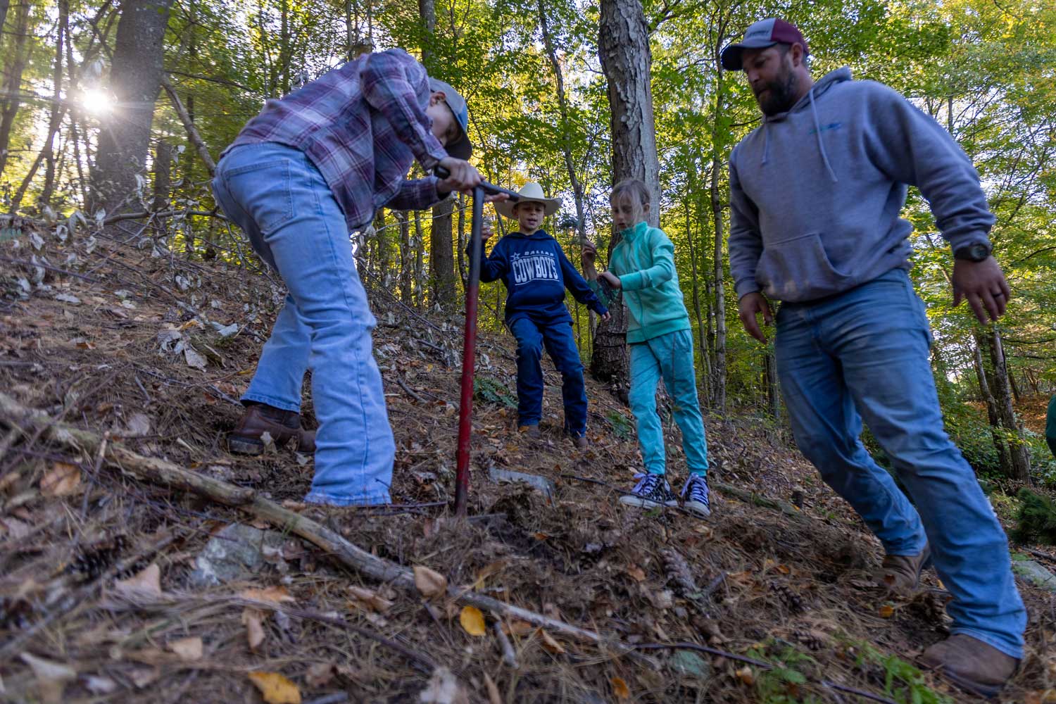 Connecticut Water employee volunteers plant trees along a reservoir in Naugatuck.